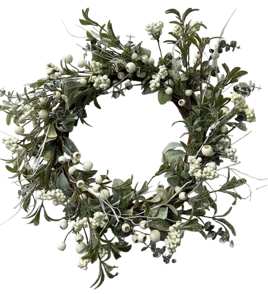 An artificial winter wreath featuring green foliage, white berries, and frosted branches.