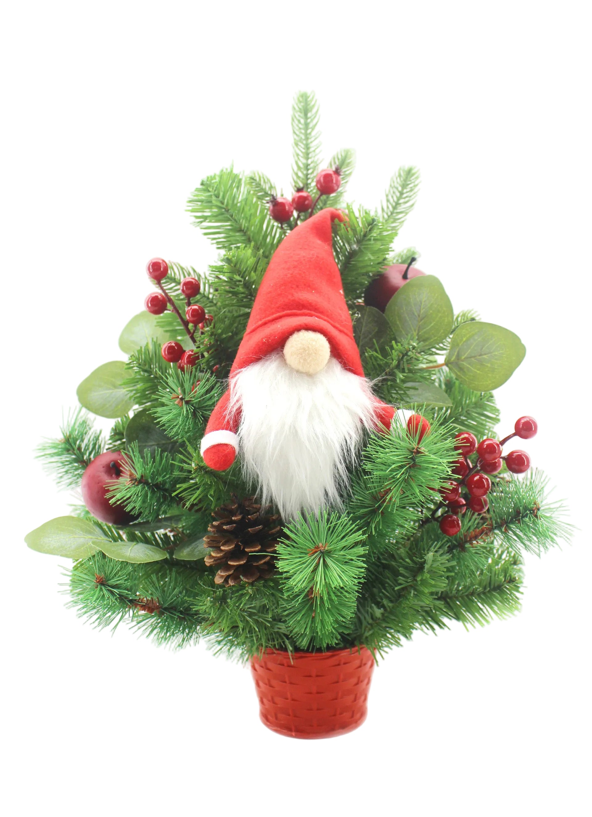 A festive Christmas gnome decoration nestled in a small red pot, surrounded by green pine branches, red berries, pinecones, and green leaves on a white background.