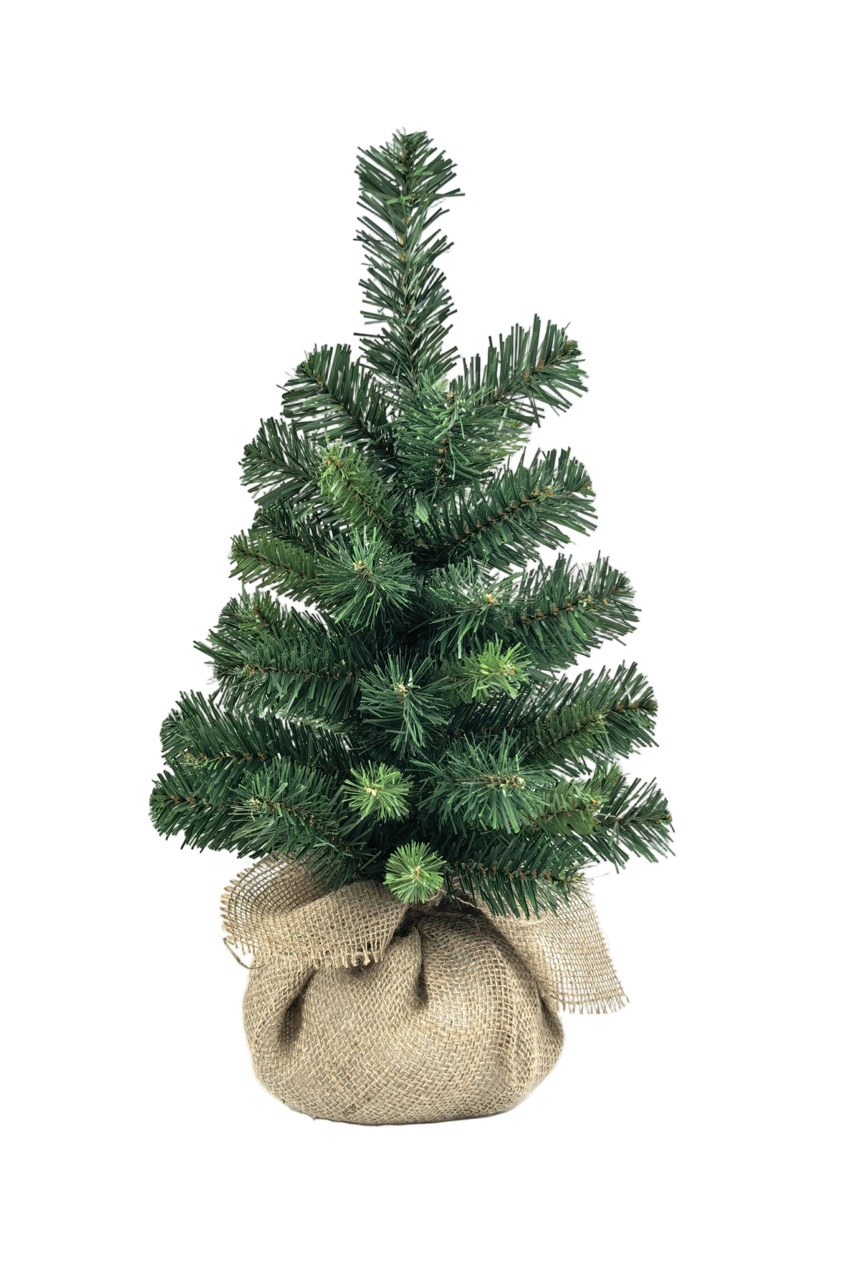 A small artificial Christmas tree with green needles, bundled at the base in a natural hessian sack.