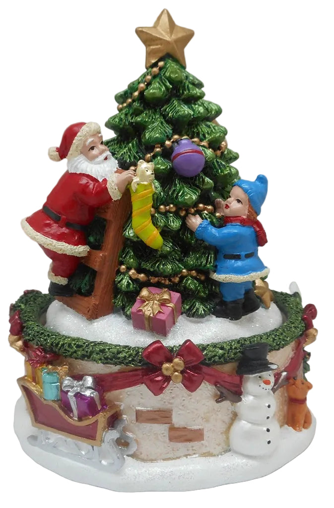 A decorative Christmas ornament featuring Santa Claus and a small figure in a blue jacket helping Santa to decorate a Christmas tree.