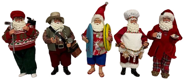 A set of five figurines depicting various Santa Claus characters in different outfits.