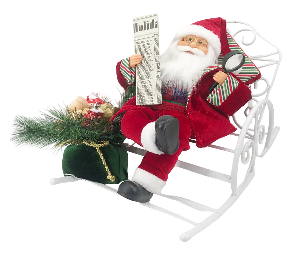A 50cm tall Santa Claus figure sitting in a chair with a newspaper and a green Christmas tree ornament beside him.