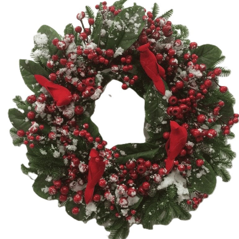 A festive Christmas wreath decorated with green pine branches, red berries, white snow-like dusting, and 4 red cardinal birds