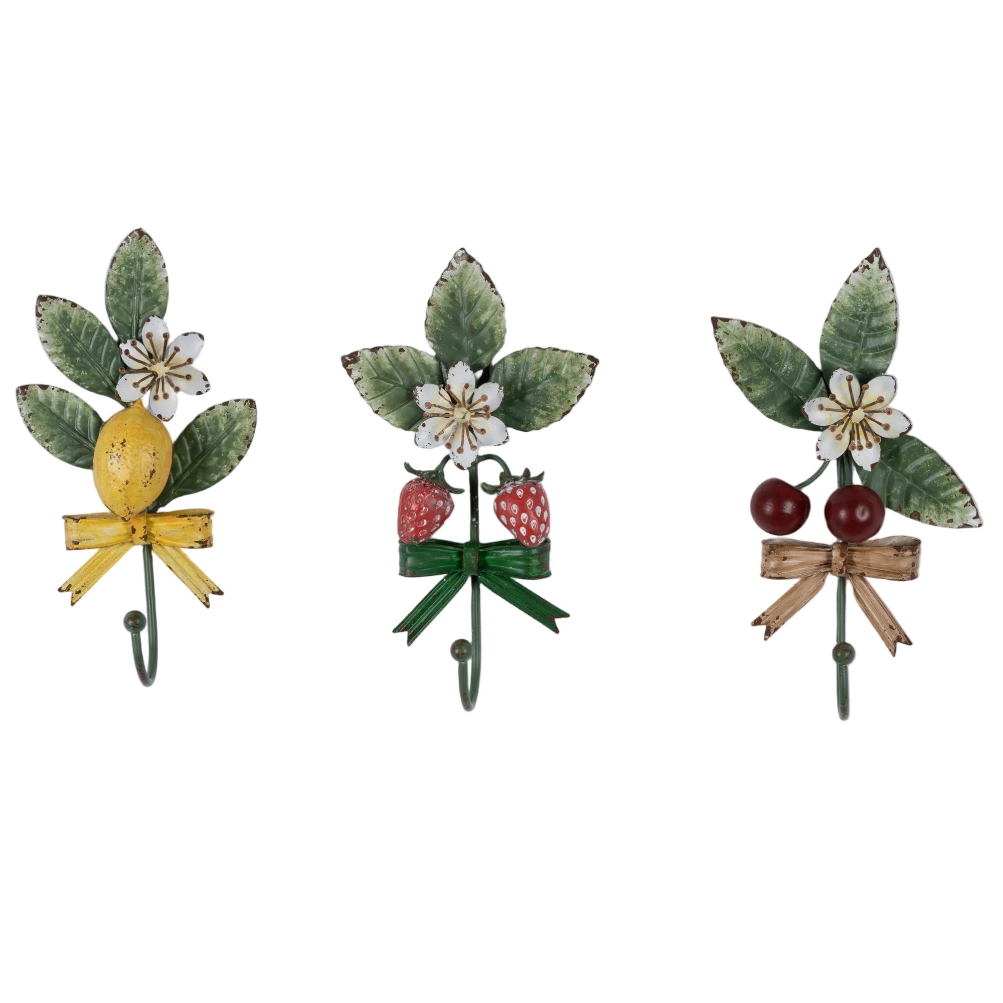 Three decorative brooches with floral and bow designs on a light gray background