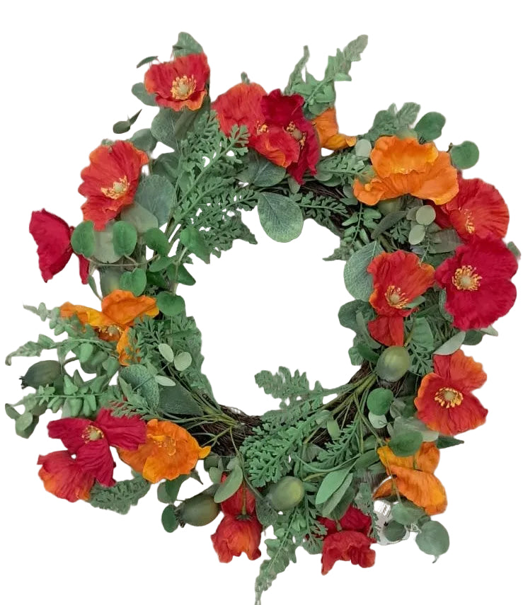 Floral wreath with red, orange, and green flowers on a wooden surface