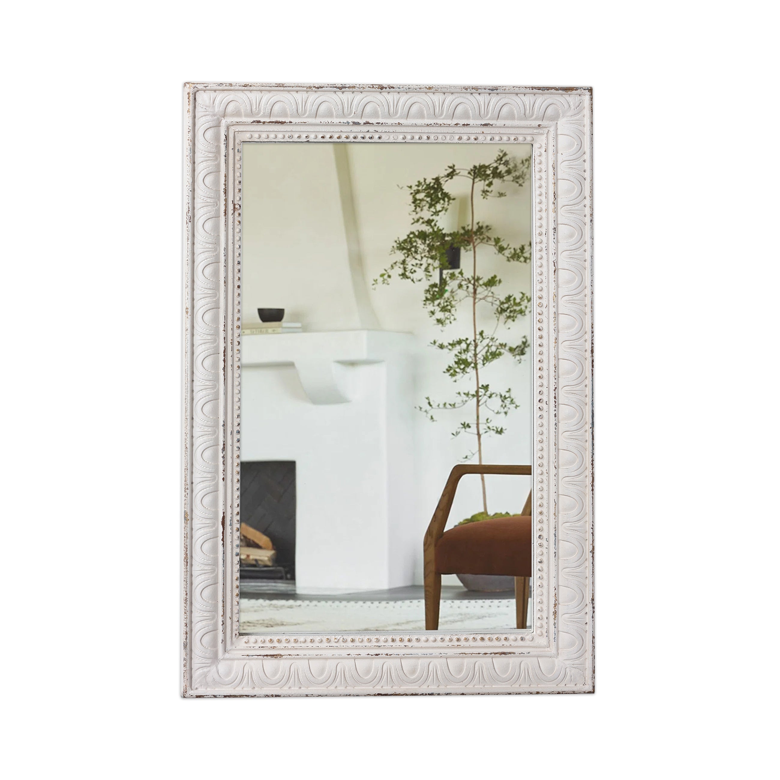 Decorative white mirror with intricate patterns.