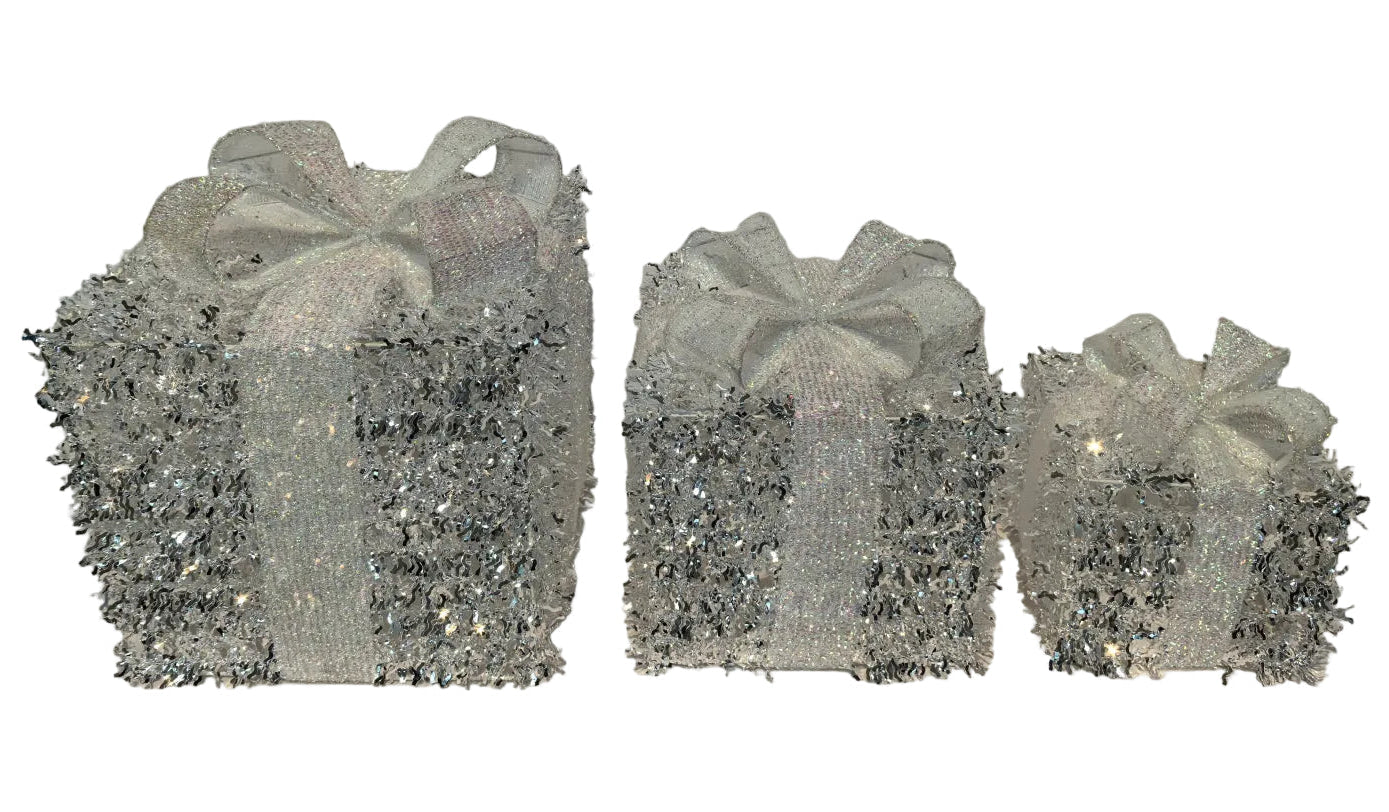 Three decorative gift boxes with ribbons on a gray background