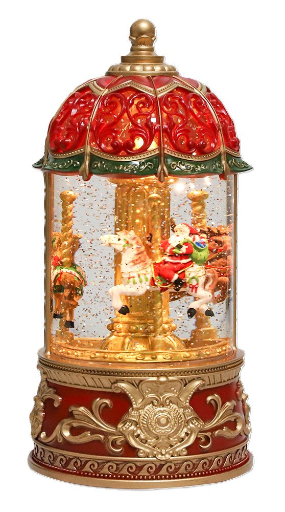 A festive Christmas carousel snow globe ornament with a red and gold dome top, gold-toned carousel figures inside, and a red-and-gold ornate base.