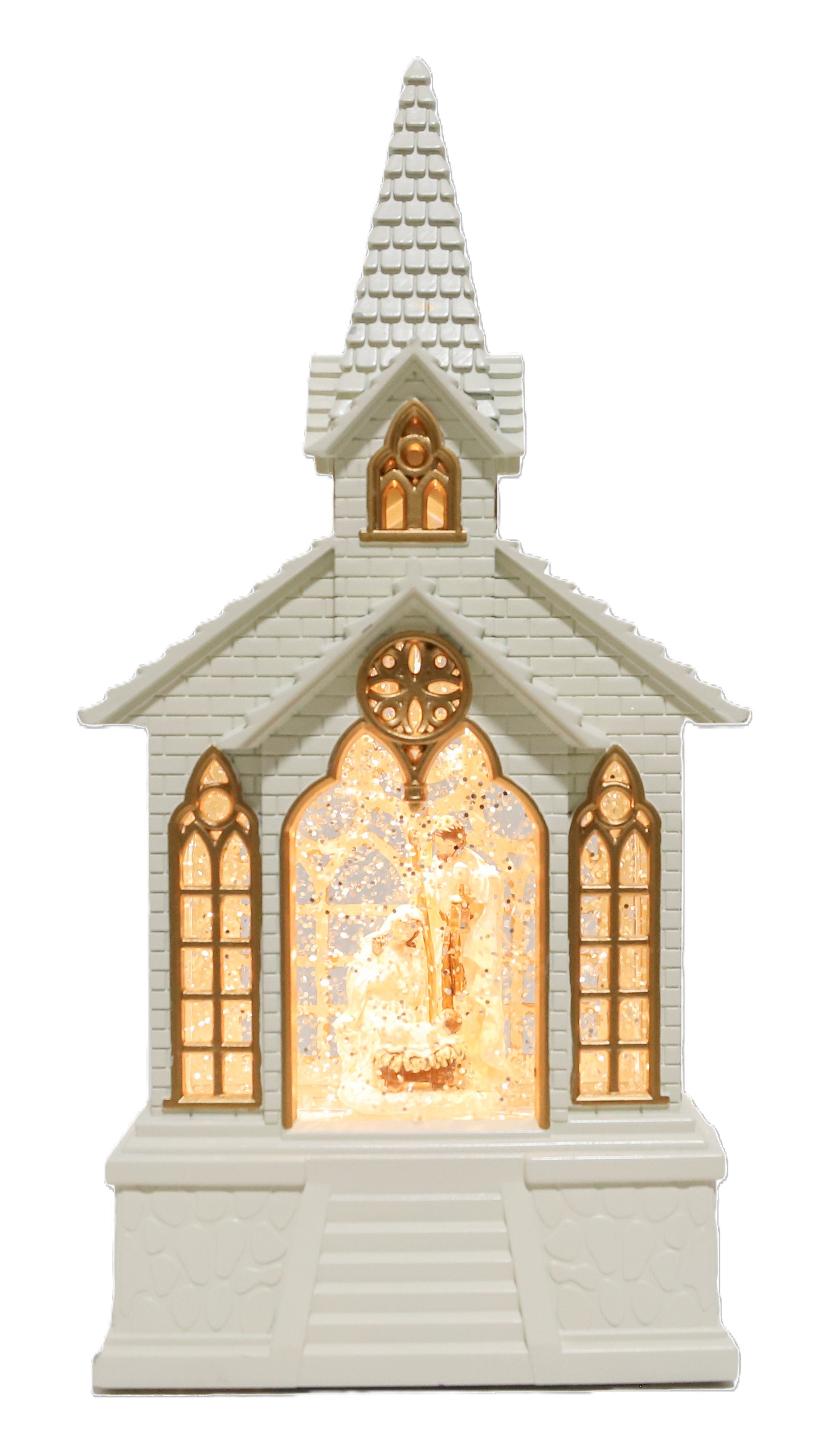 A musical small white church-shaped decorative ornament or figurine with a glowing warm light inside the arched doorway and gold-toned window details.