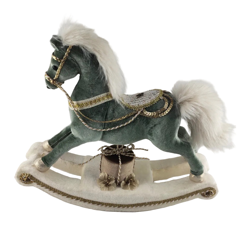 A green velvet rocking horse with a white rockered base, gold accents on the bridle, and a white mane and tail.
