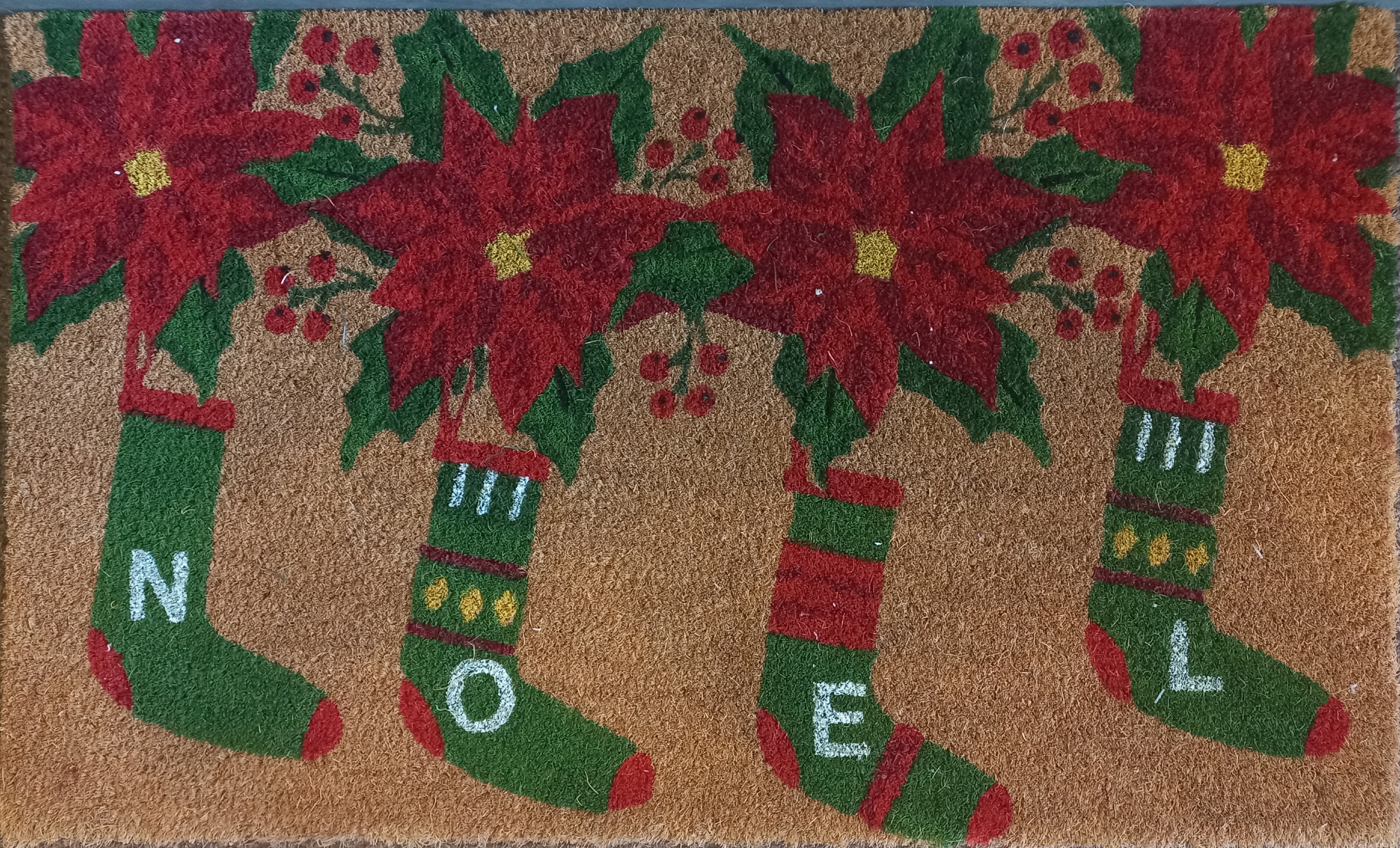 A festive Christmas themed mat featuring poinsettias and holly with the word 'Noel' in the center, in red, green, and white colors.