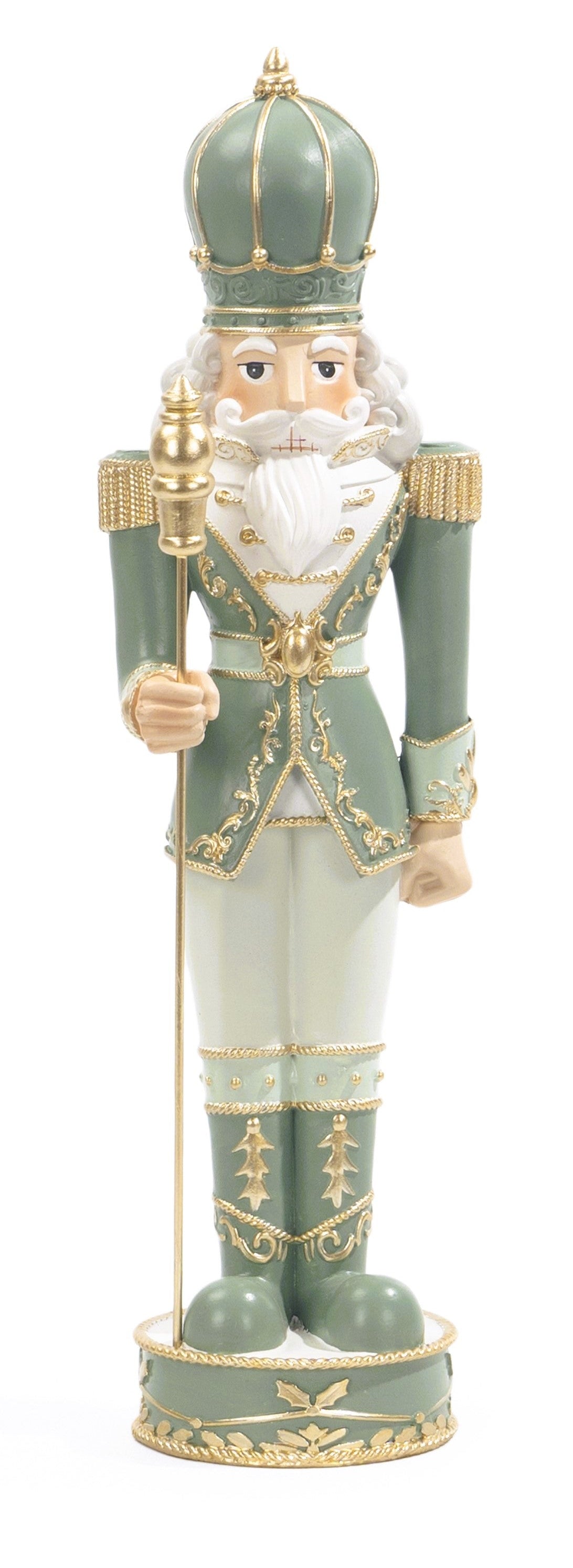 A traditional nutcracker figurine in a sage green and white uniform with gold trim, holding a gold scepter, set against a plain white background.