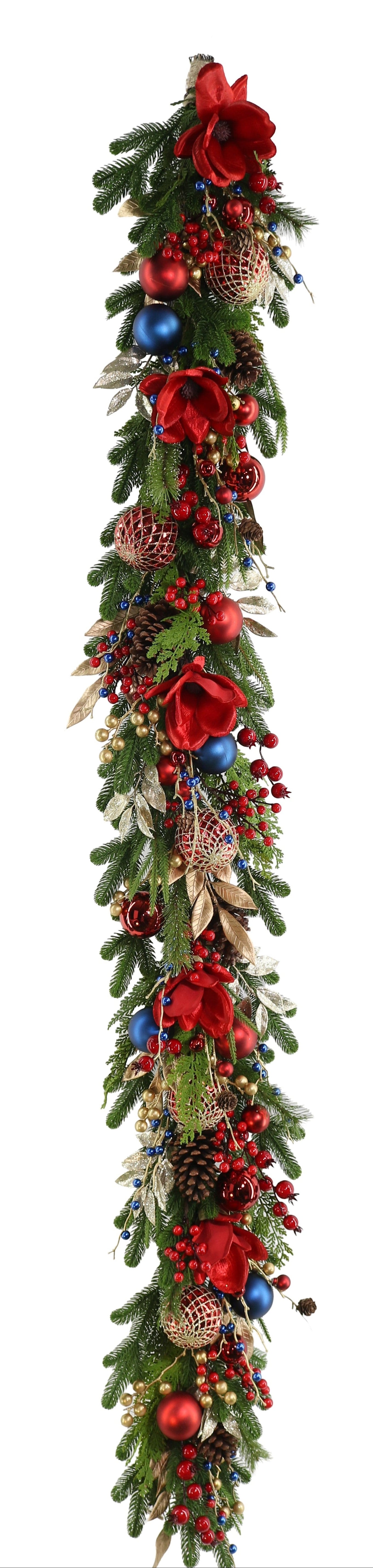 A long Christmas garland with green pine branches, red ribbons, red berries, pinecones, and blue and gold ornaments.