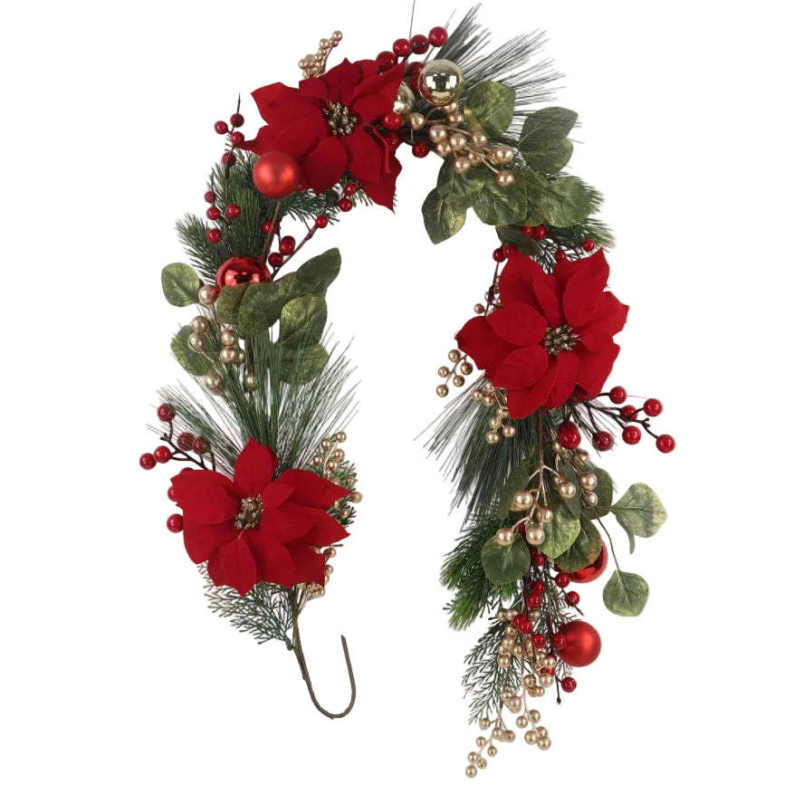 An artificial Christmas garland featuring red poinsettias, green pine needles, red berries, and small gold ornaments