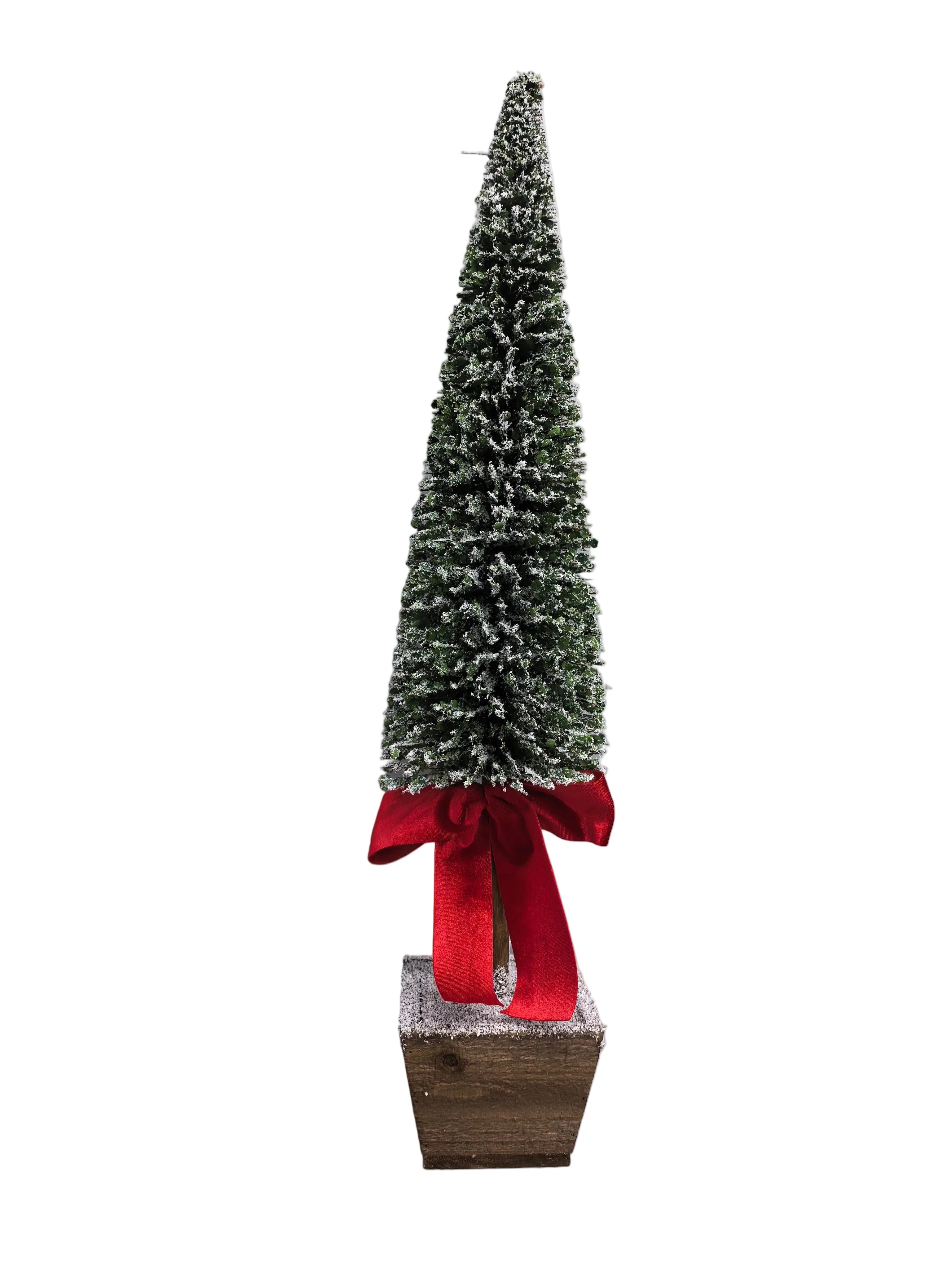 A small Christmas tree in a square wooden base, decorated with a large red ribbon bow at the bottom