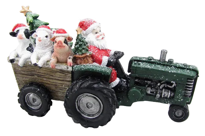 A holiday ornament featuring Santa Claus sitting on a green tractor with a Christmas tree and animals in the back trailer.