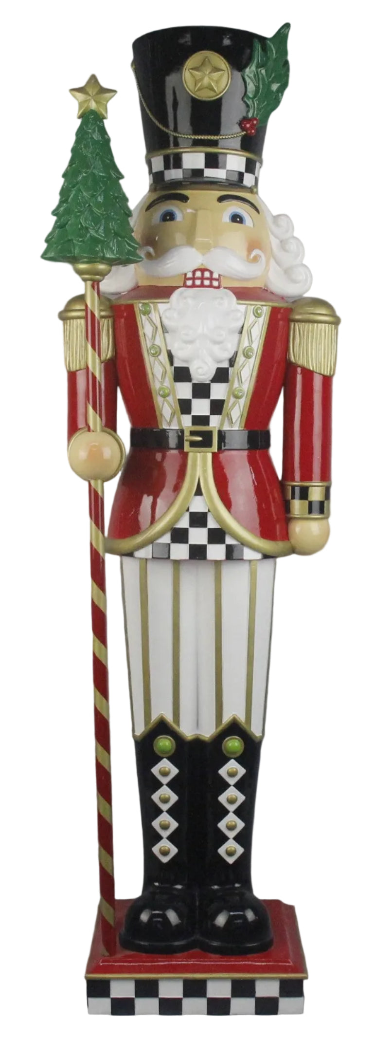A traditional style nutcracker figurine with a red jacket,  black & White checked shirt, white pants with gold stripes and black boots, with a Christmas tree on the stick