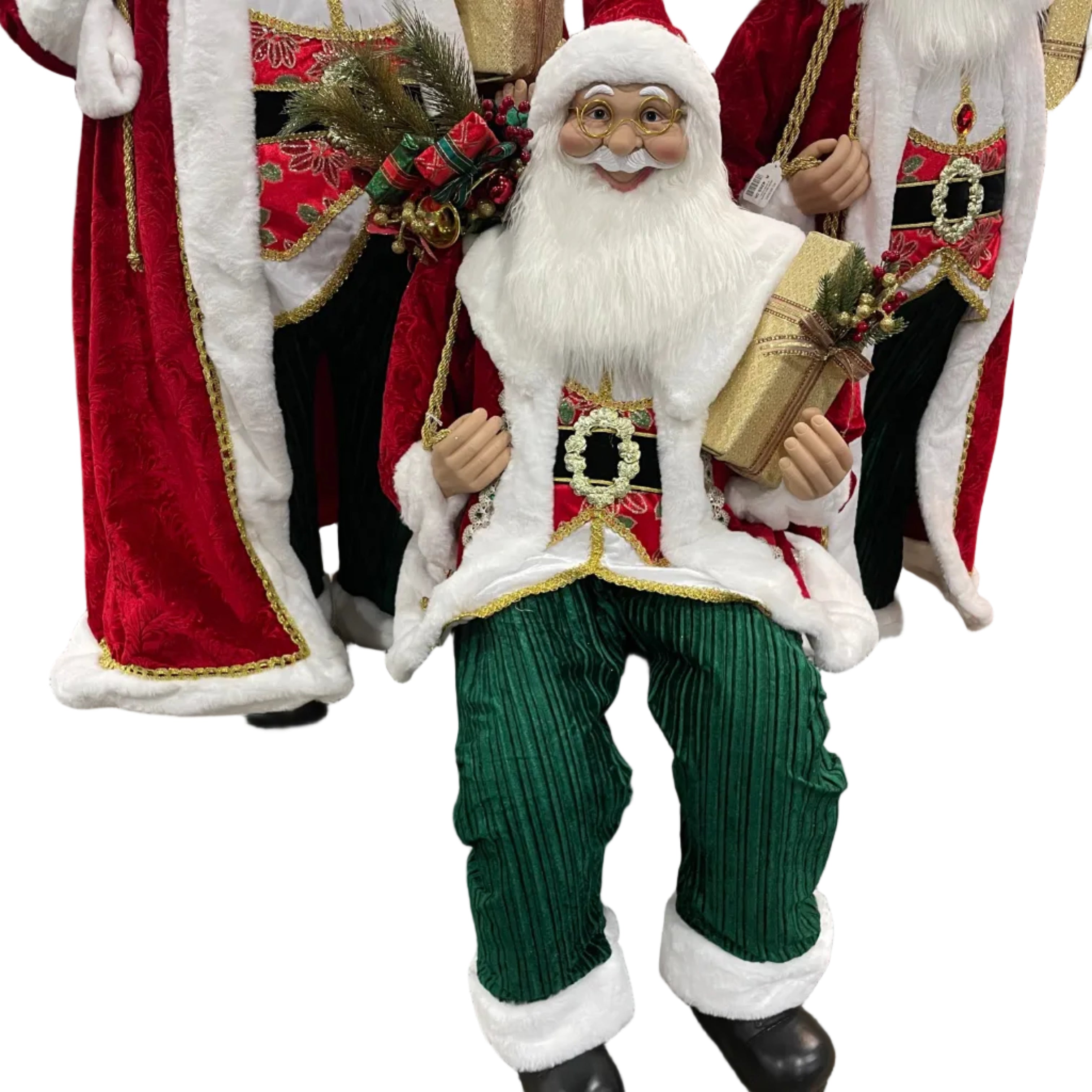 A seated Santa Claus decoration in the center, wearing a red and white suit with green striped pants, holding a wrapped gift.