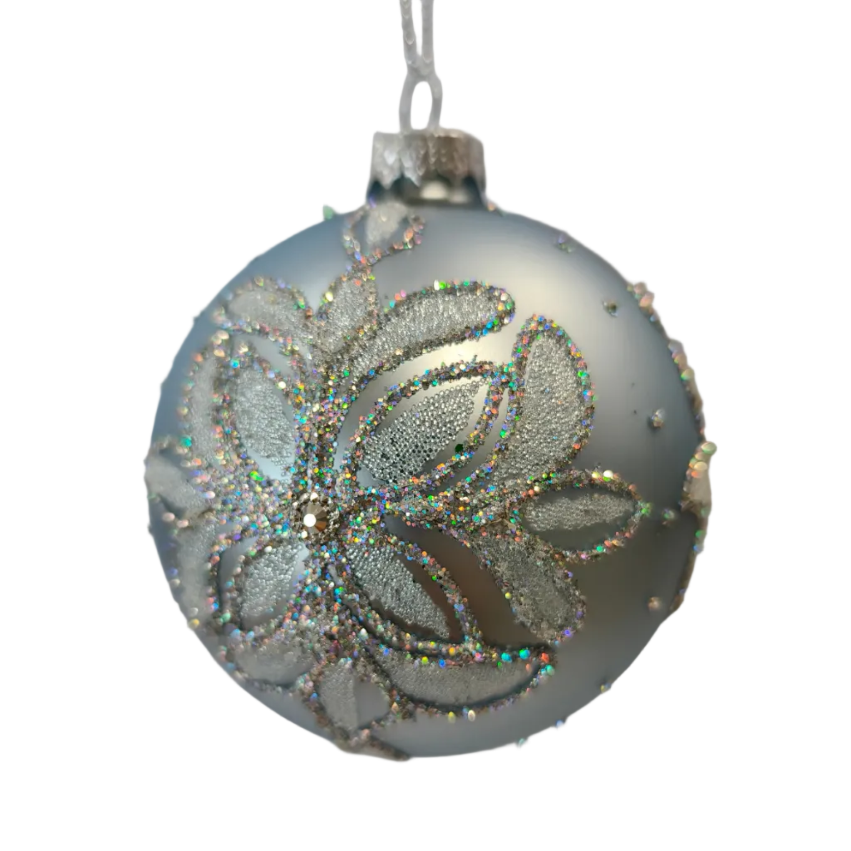 A round silver Christmas ornament with a glittery floral pattern.