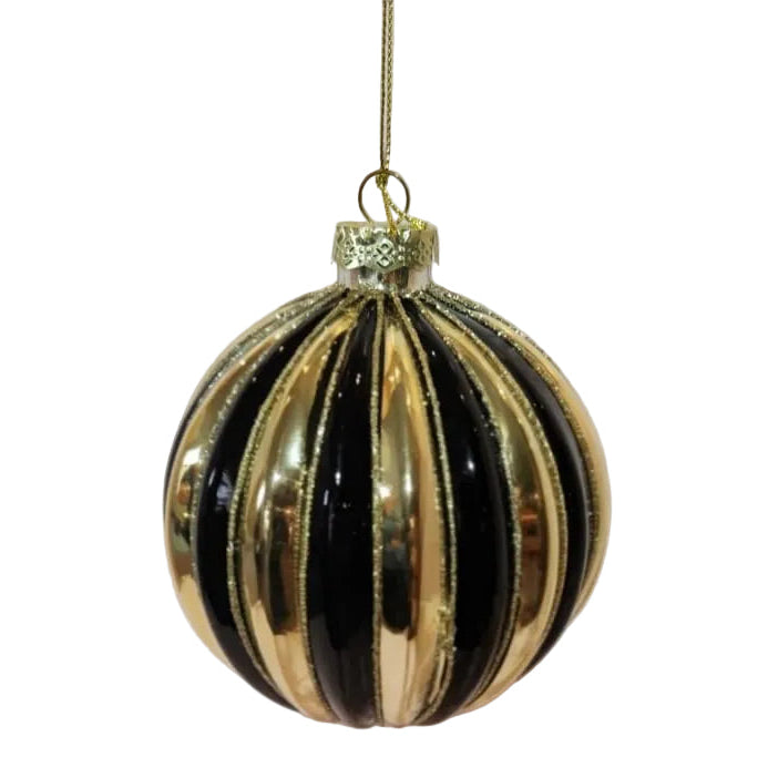 A gold and black striped glass Christmas ornament hanging from a thin gold string 