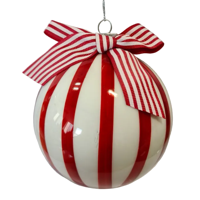 A Christmas ornament ball with bold red vertical stripes and a matching red and white striped ribbon bow at the top.