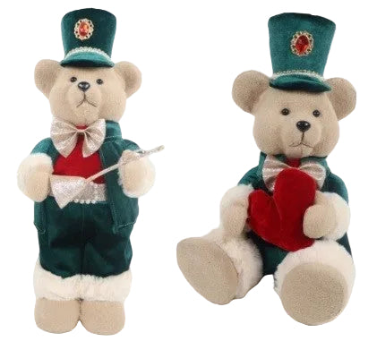 Two plush bears dressed in decorative clothing with one holding a red heart-shaped object.