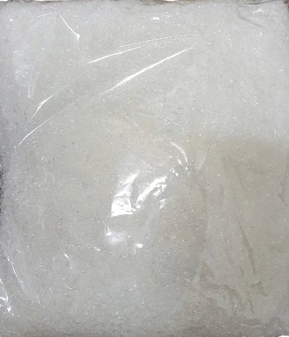 A clear plastic bag containing white artificial snow meant for craft and display purposes.